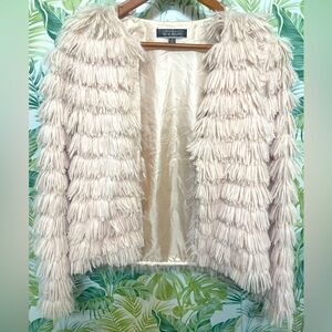 A Blue Blush pink, faux fur jacket. Fun for a night out or any party!!